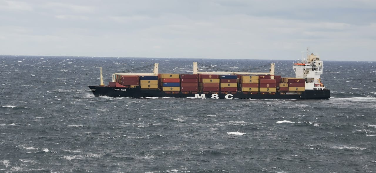 services-bg A large cargo vessel transporting containers in the choppy North Sea off the coast of Denmark.